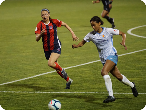 Two girls playing football